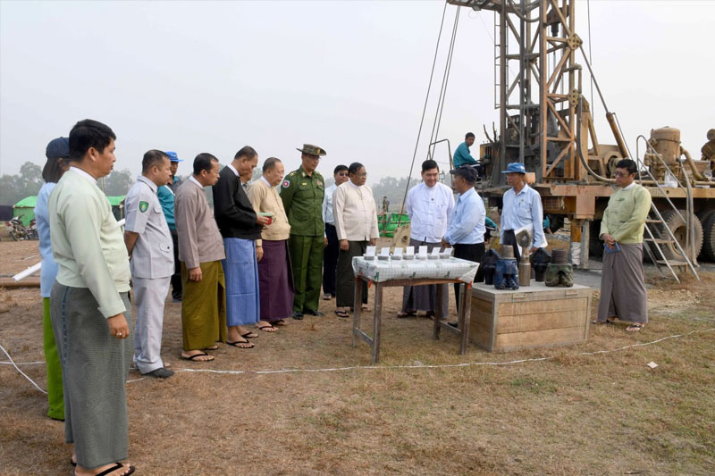 Arakan State military council officials inspect the digging of artesian wells near Thinganet Village in Sittwe Township. (Photo: Rakhine Daily)