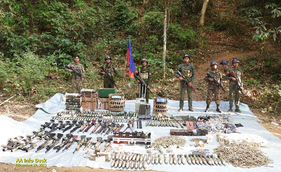 Arakan Army (AA) fighters are seen along with weapons seized from the Mrauk-U District police station.