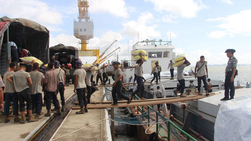 Junta soldiers unload relief supplies from a ship at Sittwe Port on July 4, 2023. (Photo: Thikyarsaychin Ngwe Thazin)