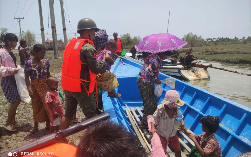 Arakan Army personnel evacuate Myebon residents. (Photo: Supplied)