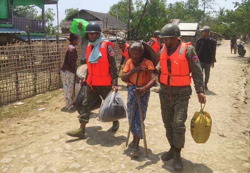 Members of the Arakan Army evacuate people in Arakan State ahead of Cyclone Mocha.