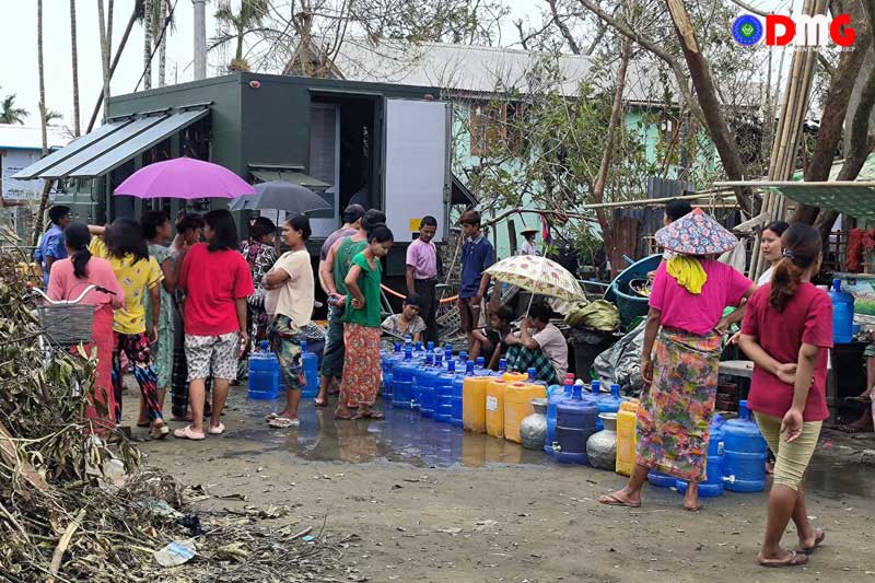 Drinking water is distributed with a water purifier in a residential part of Sittwe.