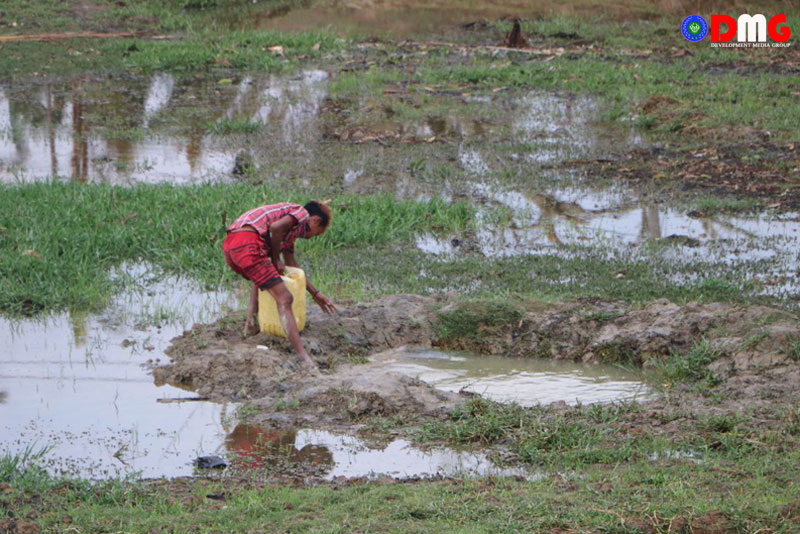 A young man from Zeditaung displacement camp in Rathedaung town fetches water.
